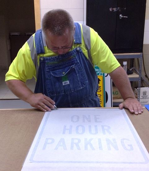 Man Drawing a Road Sign