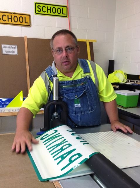 Man Creating a Road Sign