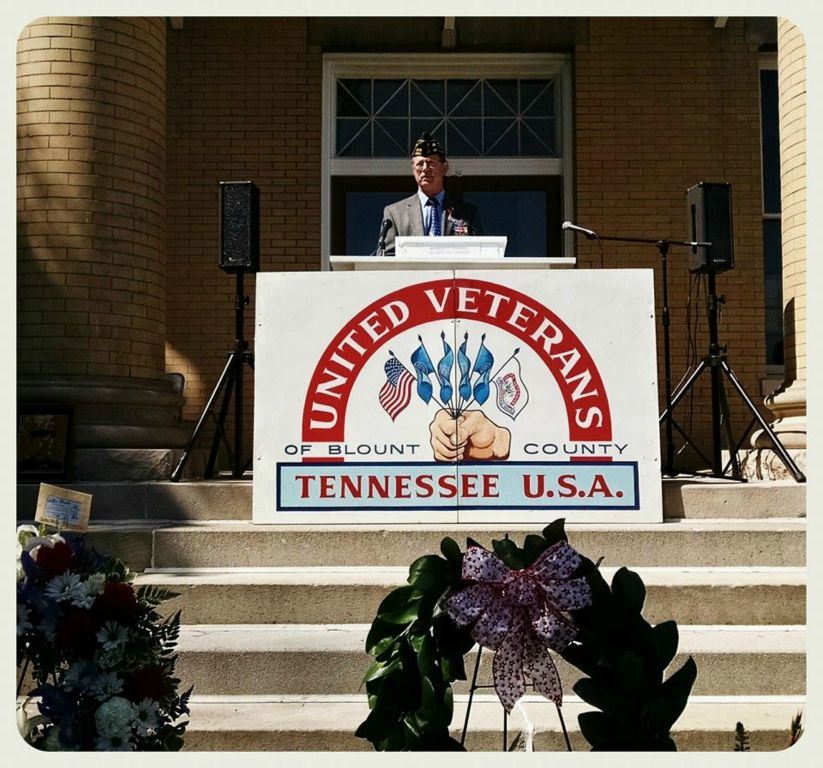 Speaker standing at podium at top of Court House stairs