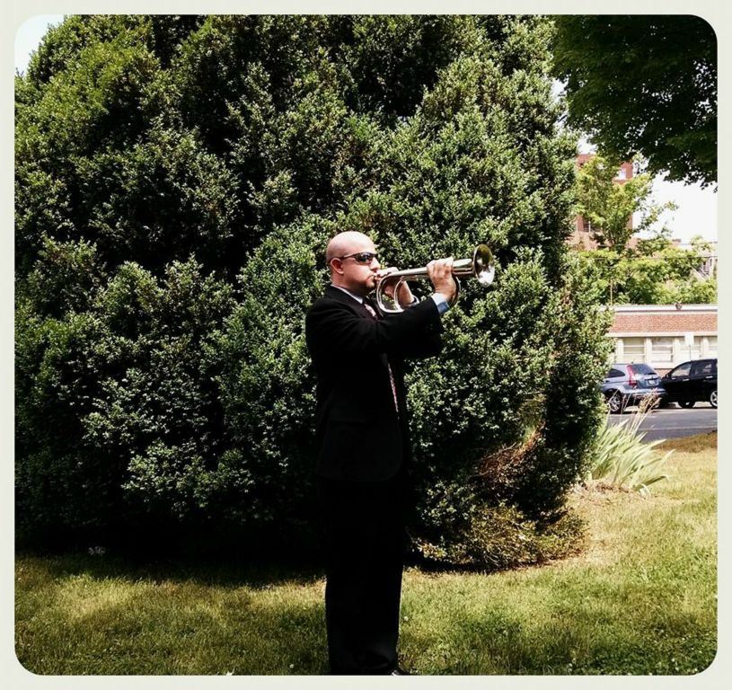 Man in suit playing trumpet