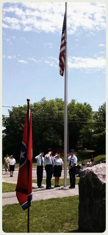 Image of American flag and service members saluting