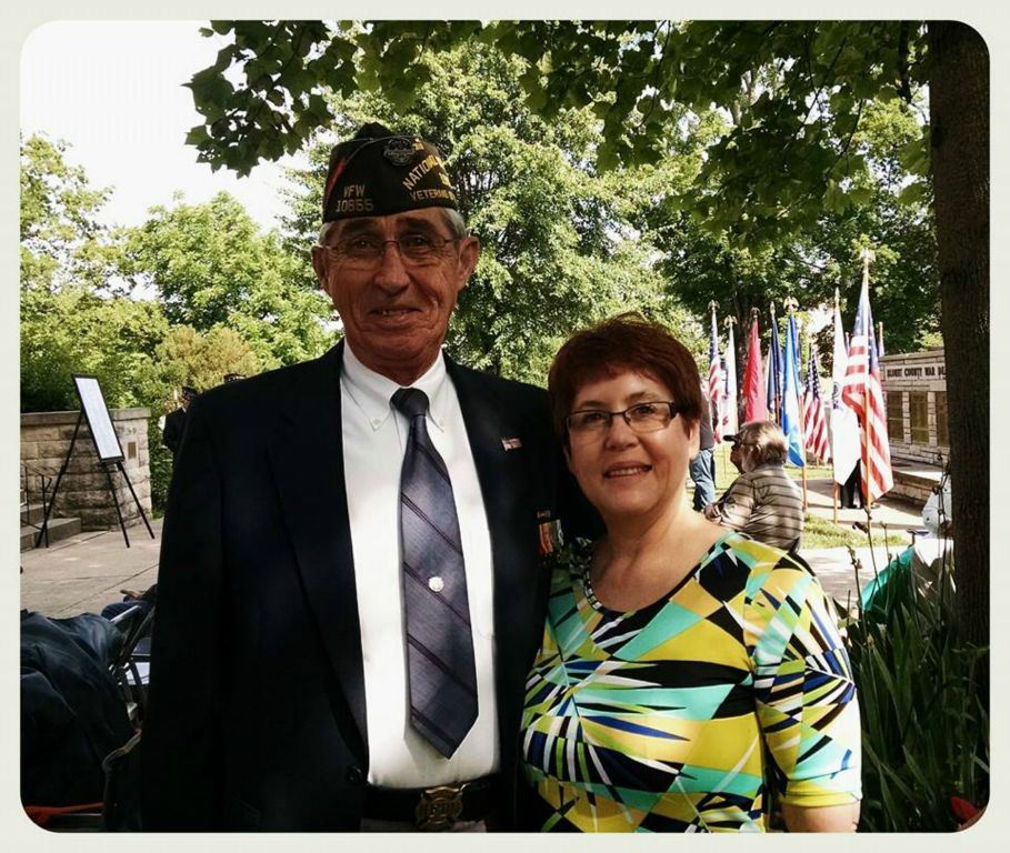 Man veteran and woman standing in shade, smiling