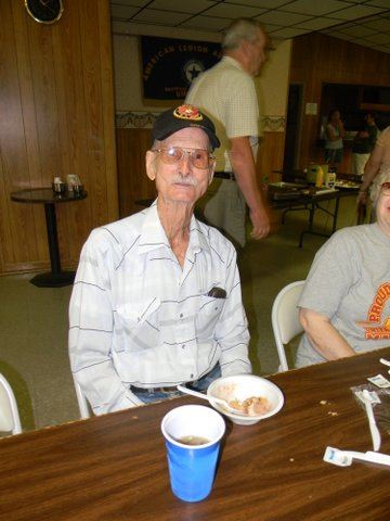 Veteran sitting at table with cup and bowl