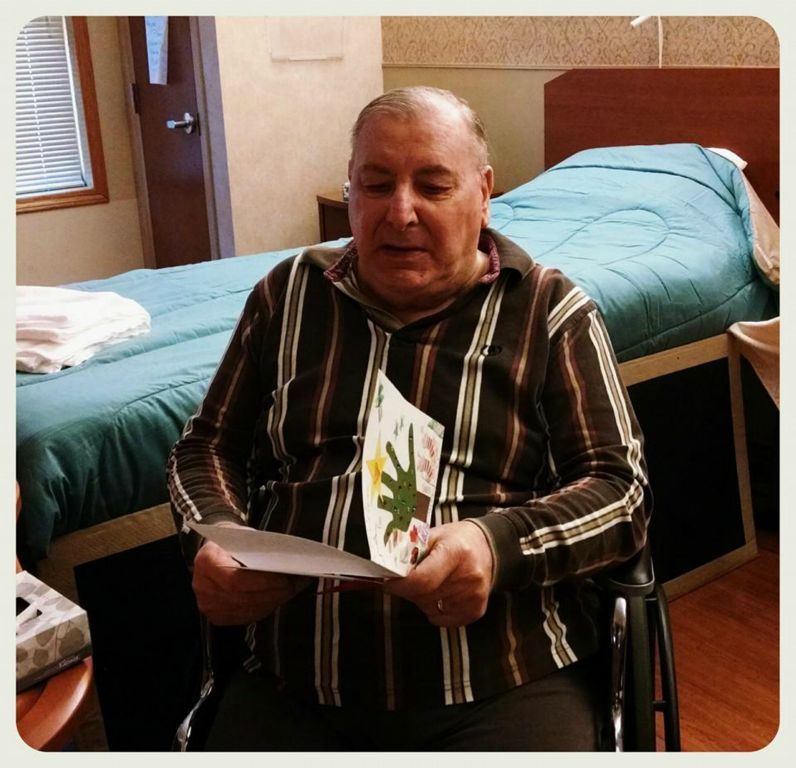 Veteran in wheelchair reads card in hand