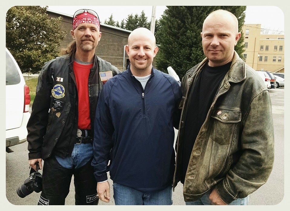 Three men stading, smiling for camera