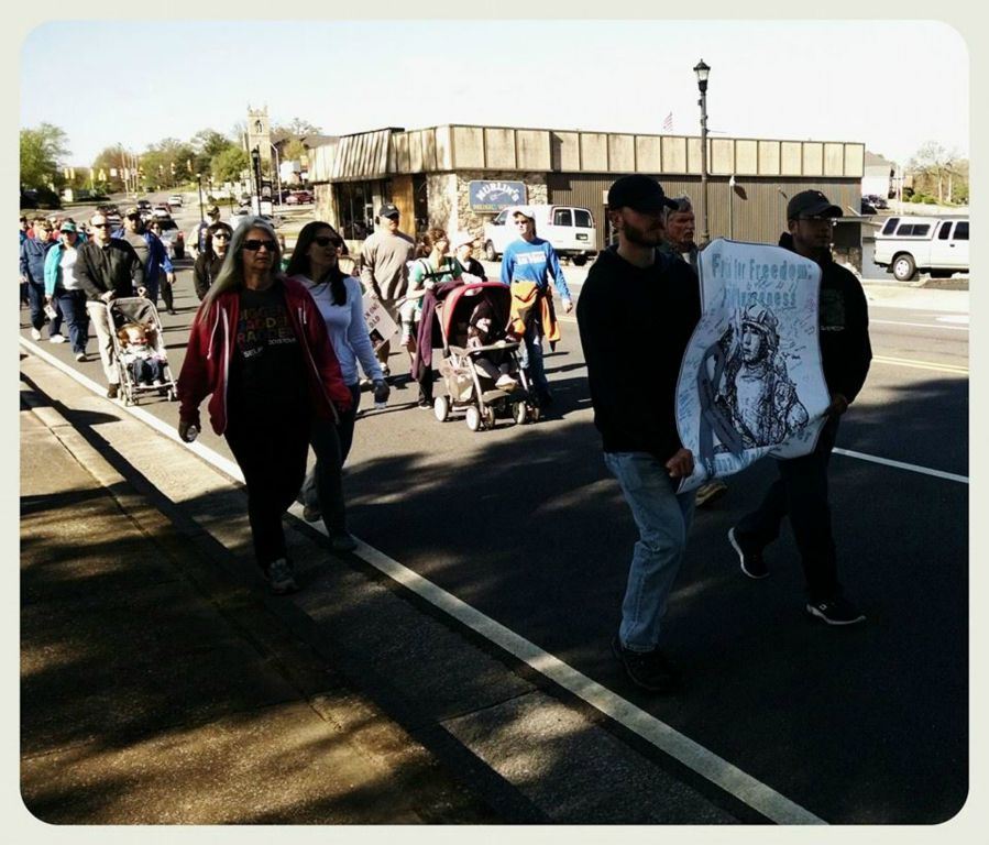 Image of line of walkers, with front two people holding Frettin' for Freedom sign