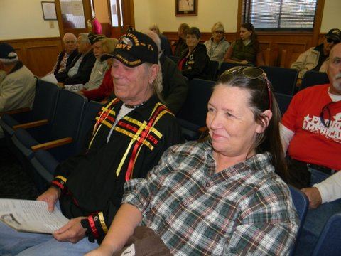 Side view of attendees sitting in rowed chairs on Court house