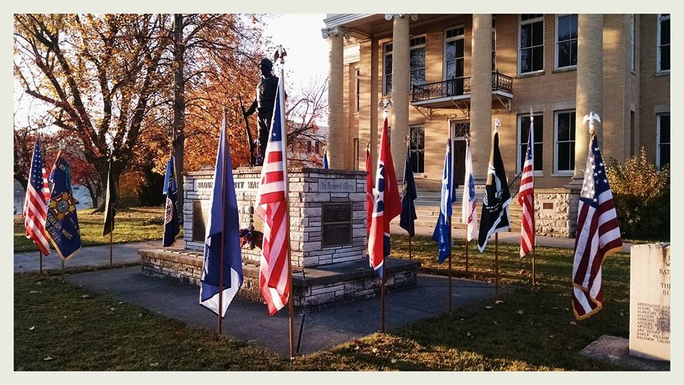 Side view of the Blount County War Dead memorial with flags around perimeter