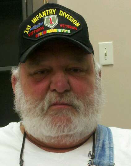 Up close image of man wearing black hat with 1st Infantry Division hat of Big Red One, Vietnam Veteran