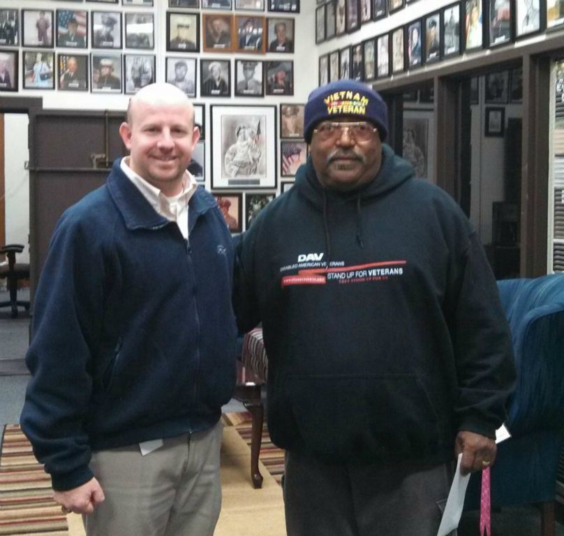 naathan Weinbaum stands side hugging with man in black sweatshirt with Vietnam Veteran hat on